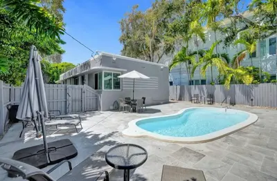 a backyard with a swimming pool and a building at Las Olas 1BR Pool Free Parking Ideal for 2 in Fort Lauderdale