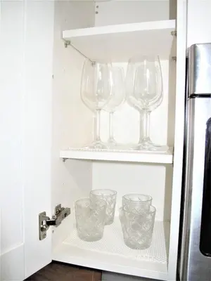 three wine glasses sitting on shelves in a refrigerator at Las Olas 1BR Pool Free Parking Ideal for 2 in Fort Lauderdale