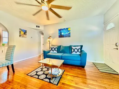 a living room with a blue couch and a ceiling fan at Las Olas 1BR Pool Free Parking Ideal for 2 in Fort Lauderdale