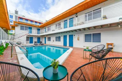 a patio with a swimming pool and chairs at The mariner Suites #22 - Beachfront Studio in Hollywood