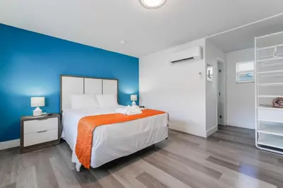 a bedroom with a bed and a blue wall at Beachfront Studio with Pool access -M24 in Hollywood