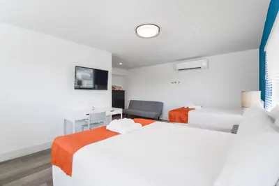 a hotel room with two beds and a desk at Family Friendly Beach Escape with pool and parking - M41 in Hollywood