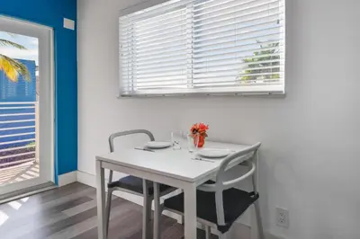 a white table and chairs in a room with a window at Family Friendly Beach Escape with pool and parking - M41 in Hollywood