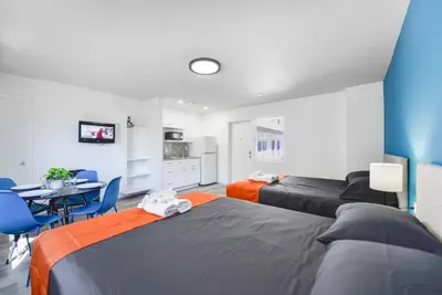 a bedroom with two beds and a table and chairs at Spacious Oceanfront Studio with pool access - M27 in Hollywood
