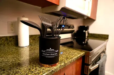 a container of kitchen utensils on a kitchen counter at City & Sea View+FREE Parking Modern Condo in Miami