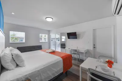 a bedroom with a bed and a desk and a television at Wonderful Studio with pool and parking at the beach! M31 in Hollywood