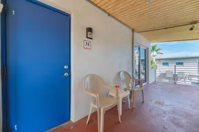 a room with two chairs and a blue door at Wonderful Studio with pool and parking at the beach! M31 in Hollywood