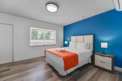 a bedroom with a bed and a blue wall at Comfortable Beachfront Studio with pool! -M32 in Hollywood