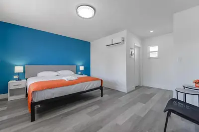 a bedroom with a bed and a blue wall at Serene Studio by the Beach with pool - M34 in Hollywood