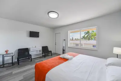 a bedroom with a bed and a desk and a window at Serene Studio by the Beach with pool - M34 in Hollywood