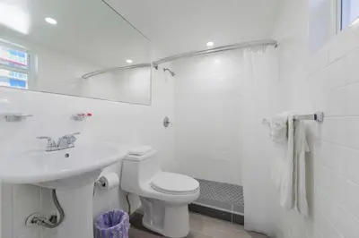 a white bathroom with a sink and a toilet at Outstanding oceanfront unit With Parking&Pool - M36 in Hollywood