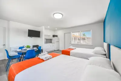 a bedroom with two beds and a table and chairs at Magical Beach Escape with Pool -M37 in Hollywood