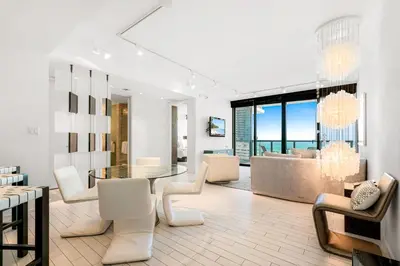 a living room with a glass table and chairs at Ocean View Residence at South Beach -1114 in Miami Beach
