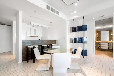 a dining room with a glass table and white chairs at Ocean View Residence at South Beach -1114 in Miami Beach