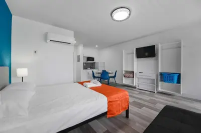 a bedroom with a large bed with an orange blanket at Ocean view Balcony with Pool & Parking -M42 in Hollywood