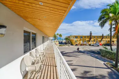a row of white chairs sitting on a balcony at Fantastic Studio at the Beach with Parking&Pool - M43 in Hollywood