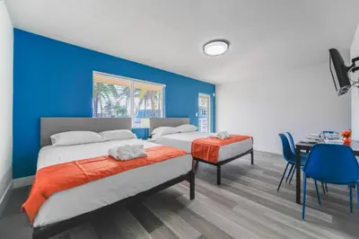 two beds in a room with a blue wall at Unit with Balcony and Parking at the beach -M45 in Hollywood