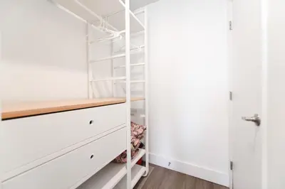 a walk in closet with white cabinets and shelves at Studio with Balcony and Parking - M47 in Hollywood