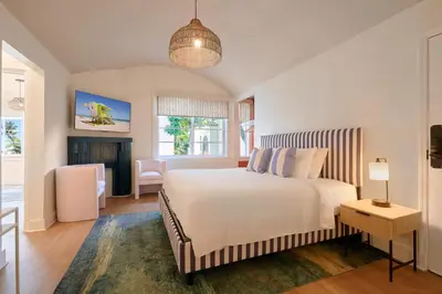 a bedroom with a large bed and a living room at Pantera Rosa in Miami Beach