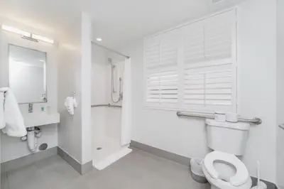 a white bathroom with a toilet and a shower at The Julia Hotel in Miami Beach