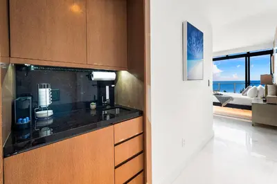 a kitchen with a counter and a view of the ocean at PENTHOUSE Ocean View Residence at South Beach - 1926 in Miami Beach