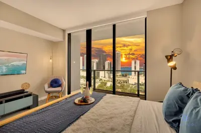 a bedroom with a large window with a view of the city at Modern Miami Gem - City View Condo - Free Parking in Miami