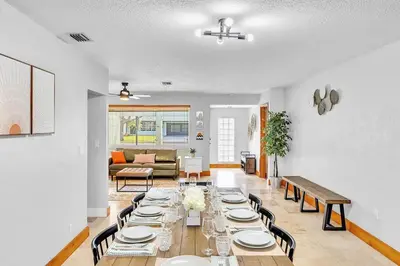 a dining room with a long table and chairs at Pool Heat I Firepit and BBQ I 75