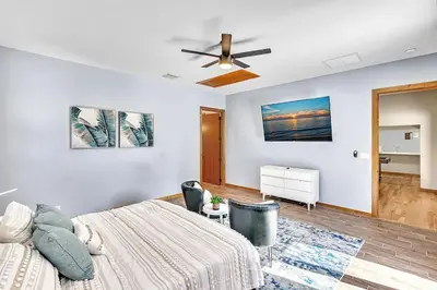 a bedroom with a bed and a ceiling fan at Pool Heat I Firepit and BBQ I 75
