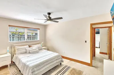 a bedroom with a bed and a ceiling fan at Pool Heat I Firepit and BBQ I 75
