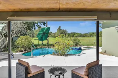an open patio door with a pool in a yard at Pool Heat I Firepit and BBQ I 75