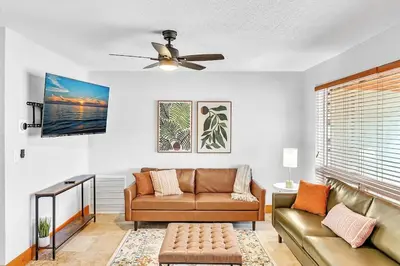 a living room with a couch and a ceiling fan at Pool Heat I Firepit and BBQ I 75