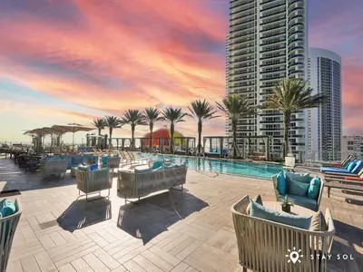 a resort with a pool and palm trees and a building at Insane Ocean View Balcony, Beachfront Resort, Pool in Hollywood