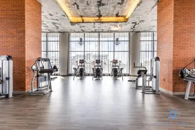 a gym with a row of chairs in a room with windows at High Floor with Stunning Views, Amazing Pools in Hollywood