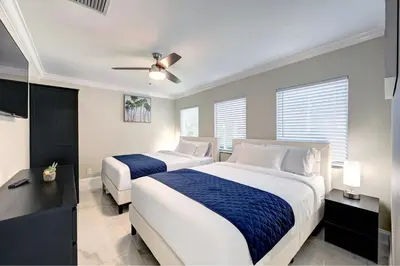 a bedroom with two beds and a ceiling fan at Deluxe 5BR & 3BA Villa in Hollywood Lakes near Beach in Hollywood
