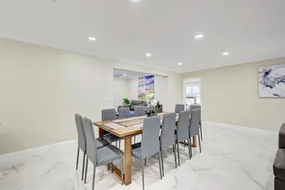 a dining room with a wooden table and chairs at Deluxe 5BR & 3BA Villa in Hollywood Lakes near Beach in Hollywood