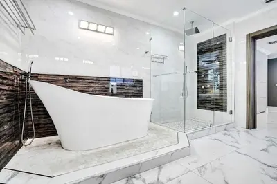 a bathroom with a tub and a glass shower at Spectacular 5BR & 5BA Villa in Hollywood Lakes in Hollywood