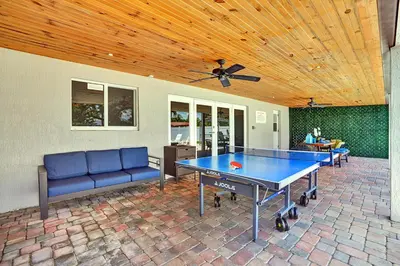 a ping pong table in the middle of a patio at Spectacular 5BR & 5BA Villa in Hollywood Lakes in Hollywood
