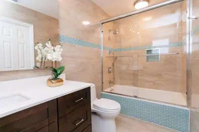 a bathroom with a tub and a toilet and a shower at Luxury 5BR Villa Heated Pool near Beach & Casino in Dania Beach