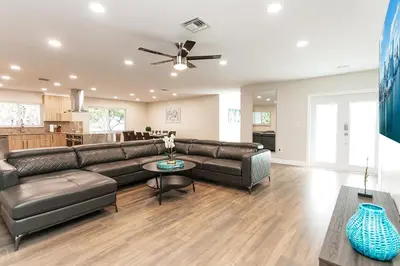 a living room with a couch and a table at Luxury 5BR Villa Heated Pool near Beach & Casino in Dania Beach