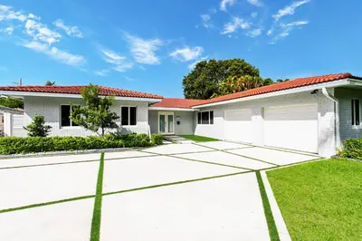a house with a tennis court in front of it at Luxury 5BR Villa Heated Pool near Beach & Casino in Dania Beach