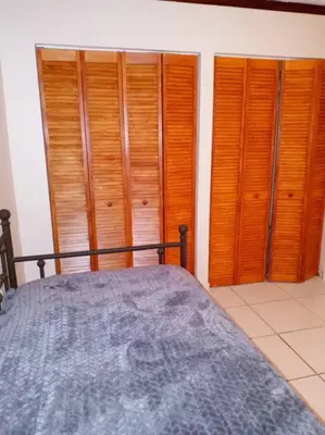 a bedroom with wooden closets and a bed at Pool home in Miami in Tamiami