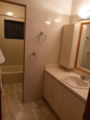 a bathroom with a sink and a mirror at Pool home in Miami in Tamiami