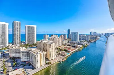 an aerial view of a city with a river and buildings at Beachwalk Resort - Waterfront huge 3-Bedroom apartment with direct ocean-view! in Hallandale Beach