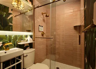 a bathroom with a shower with a toilet and a sink at FOUND Hotels, Miami Beach, Series by Marriott in Miami Beach