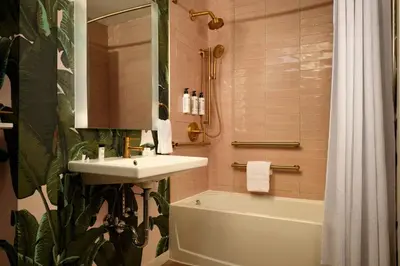 a bathroom with a sink and a bath tub at FOUND Hotels, Miami Beach, Series by Marriott in Miami Beach