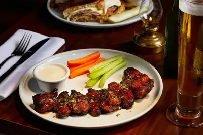 a plate of food with meat and vegetables on a table at FOUND Hotels, Miami Beach, Series by Marriott in Miami Beach