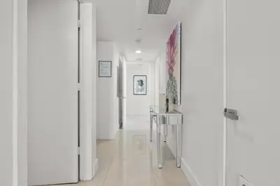 a hallway with white walls and a hallway with white floors at BeachWalk Resort - VIP TOWER - OCEANVIEW UNIT 3 BEDROOM & 3 BATHROOM in Hallandale Beach