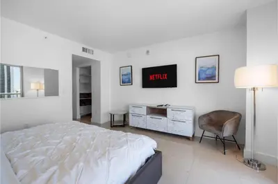 a bedroom with a bed and a desk and a chair at BeachWalk Resort - VIP TOWER - OCEANVIEW UNIT 3 BEDROOM & 3 BATHROOM in Hallandale Beach
