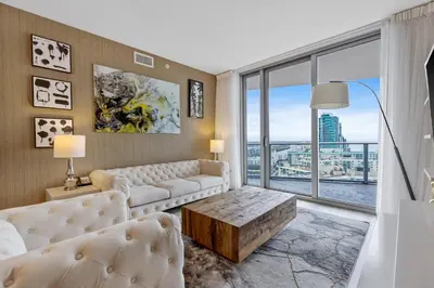 a living room with a couch and a large window at Hyde Resort Beachfront Condo #1904 - GORGEOUS 2BD & 2BA APT WITH OCEAN VIEW in Hollywood
