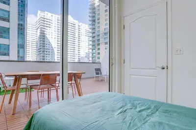 a bedroom with a bed and a table and chairs at Best of Brickell's Luxury Suite with Pool and Gym in Miami